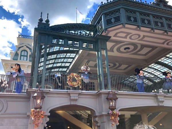 characters in 50th outfits at magic kingdom train station